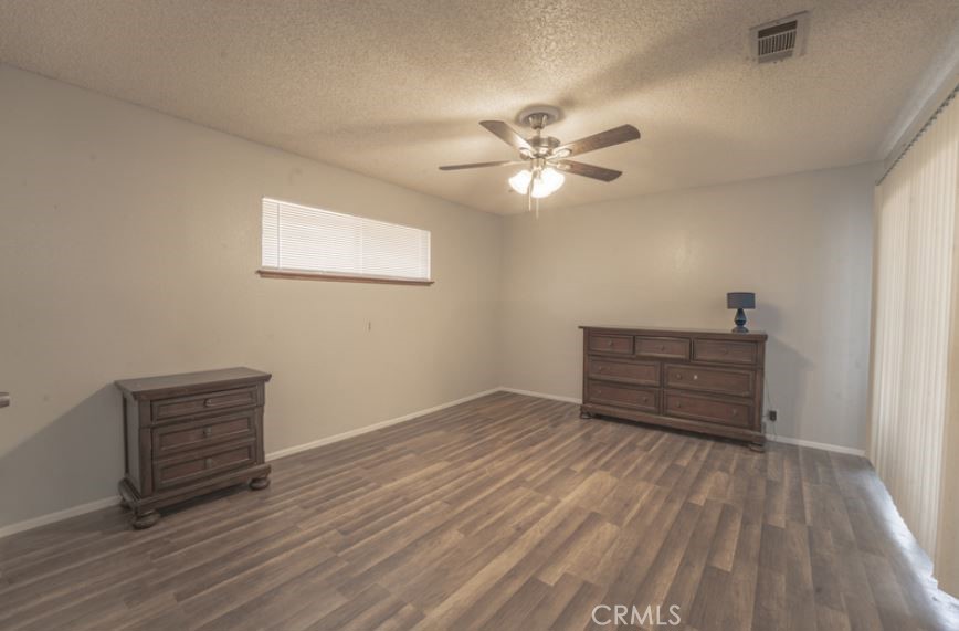 15032 Birch Street Hesperia, CA 92345 - Photo 15 of 21 a view of room with wooden floor and ceiling fan
