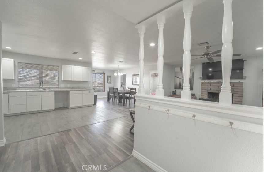 15032 Birch Street Hesperia, CA 92345 - Photo 8 of 21 a open kitchen with white cabinets and stainless steel appliances