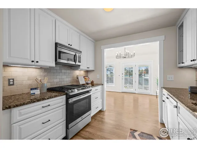 a kitchen with stainless steel appliances granite countertop a stove and cabinets