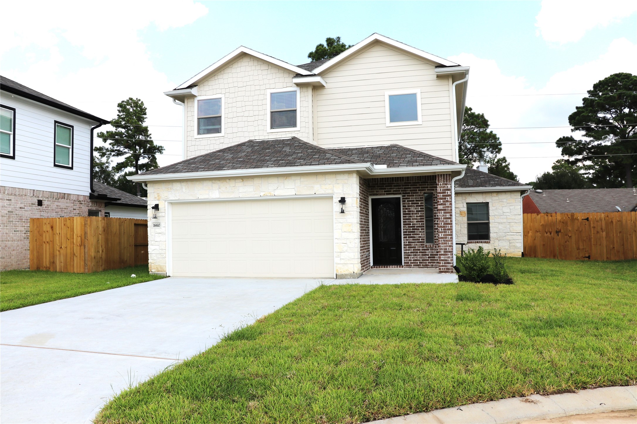 a front view of a house with a yard and garage