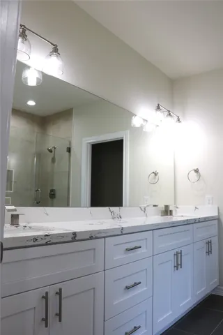 a bathroom with a double vanity sink and a mirror