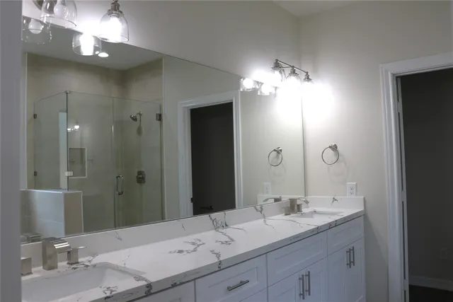 a bathroom with a sink double vanity and a mirror