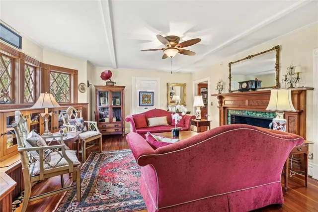 a living room with furniture ceiling fan and a rug