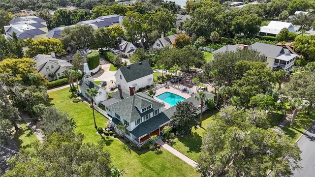an aerial view of residential house with outdoor space and trees all around