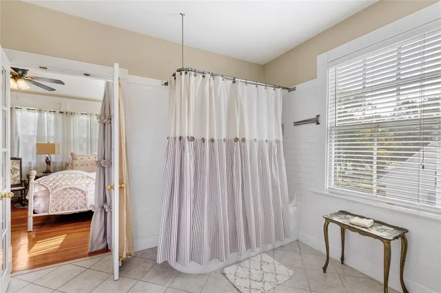 a view of a hallway with furniture and wooden floor