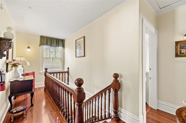 a bedroom with a bed and two windows