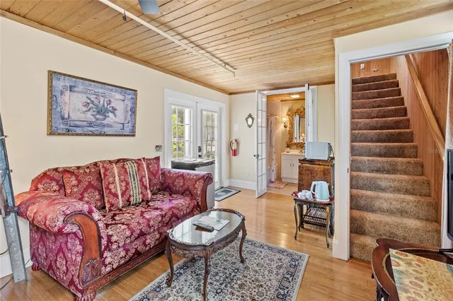 an aerial view of a house with a yard and lake view