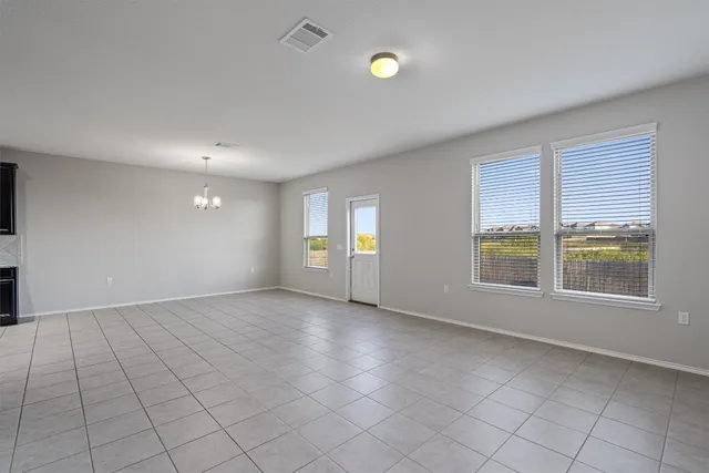 a view of a kitchen with stainless steel appliances granite countertop a refrigerator a sink dishwasher and white cabinets with wooden floor