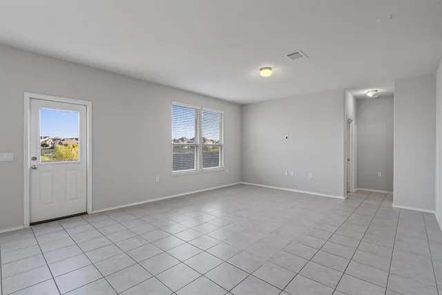 an empty room with windows and closet