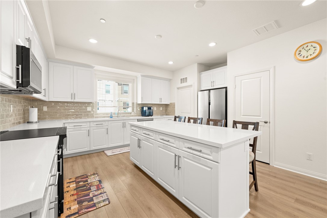 8633 Amherst Street Santee, CA 92071 - Photo 13 of 61 a kitchen with white cabinets and white appliances