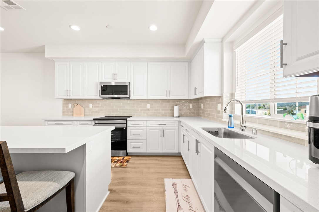 8633 Amherst Street Santee, CA 92071 - Photo 16 of 61 a kitchen with a sink stove top oven and cabinets
