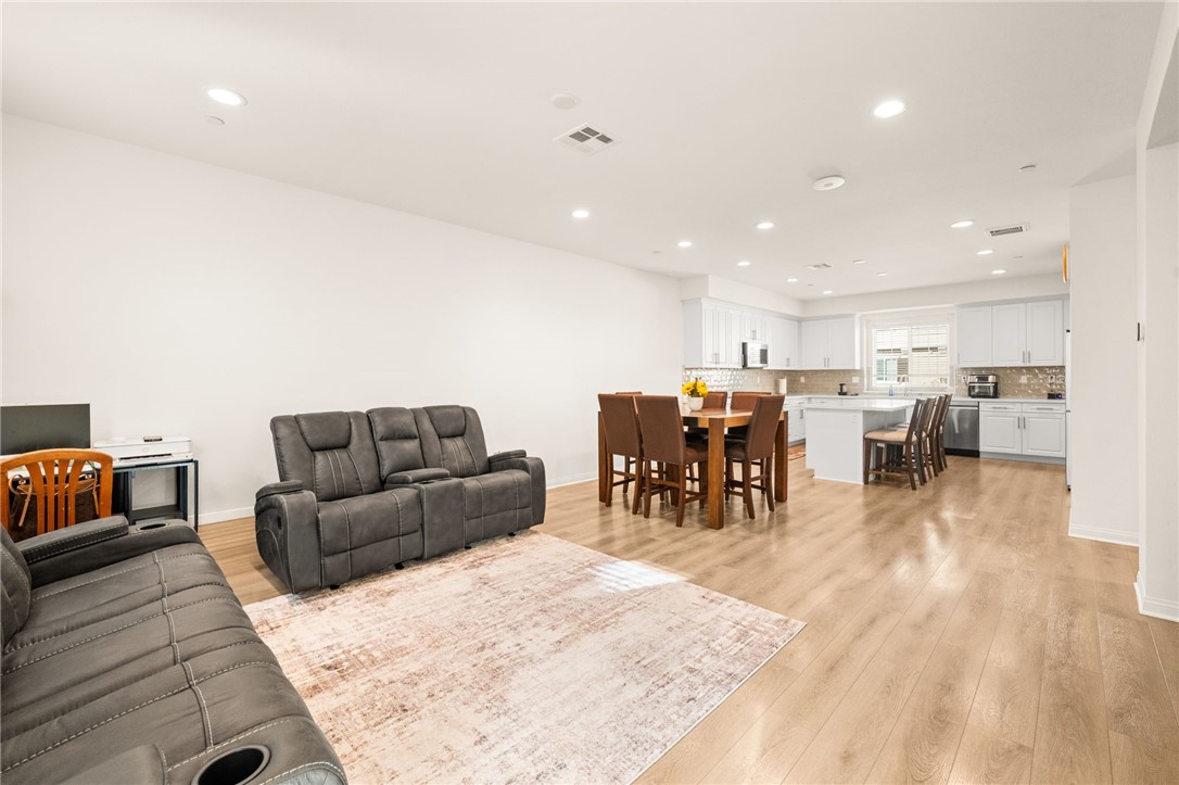 8633 Amherst Street Santee, CA 92071 - Photo 22 of 61 a living room with furniture and kitchen view with wooden floor