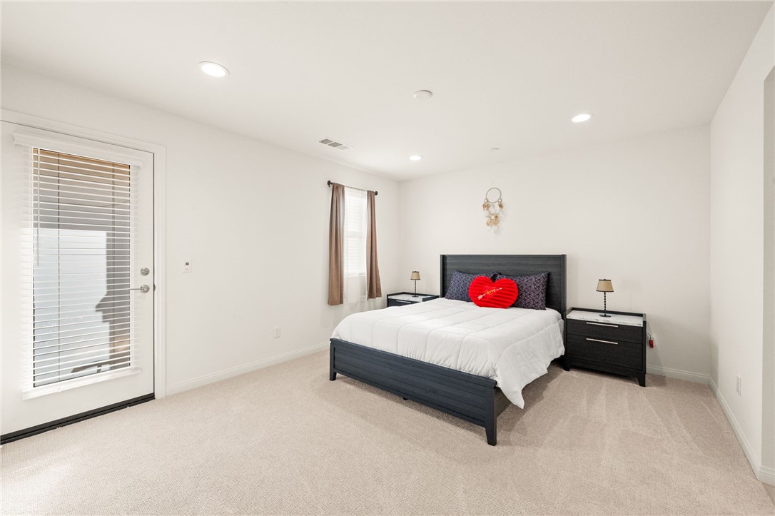 8633 Amherst Street Santee, CA 92071 - Photo 31 of 61 a bedroom with a large bed and a large window