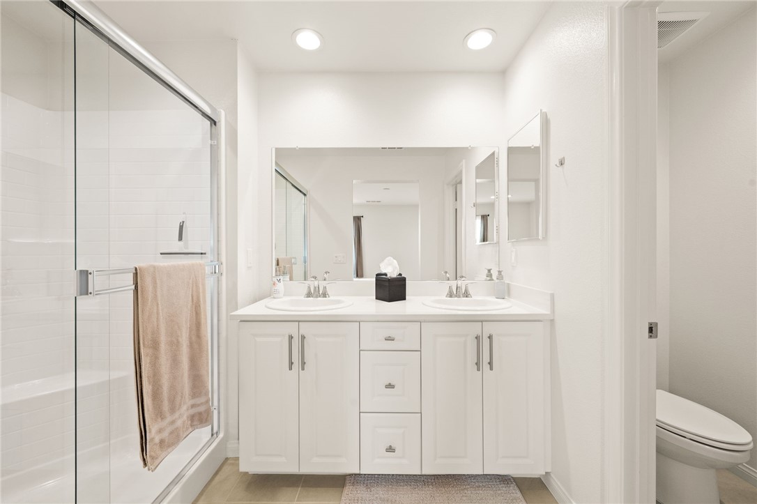 8633 Amherst Street Santee, CA 92071 - Photo 36 of 61 a bathroom with a sink a toilet and a mirror