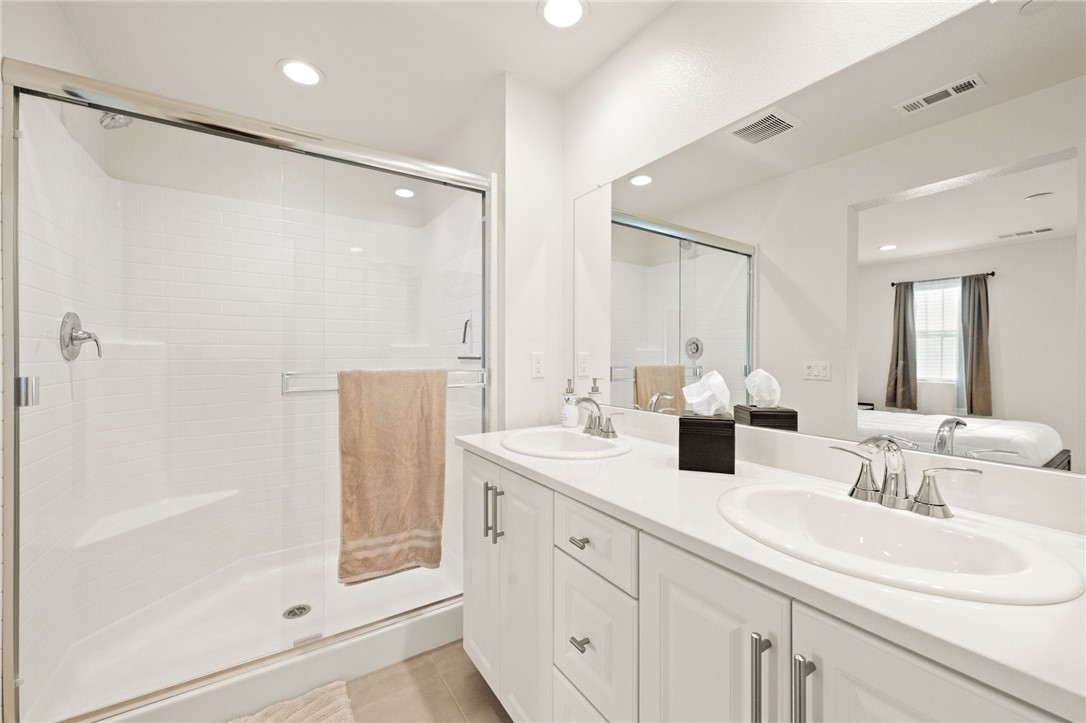 8633 Amherst Street Santee, CA 92071 - Photo 37 of 61 a bathroom with double sink and a mirror
