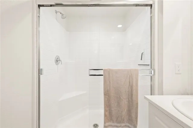 a bedroom with a bed and a large mirror