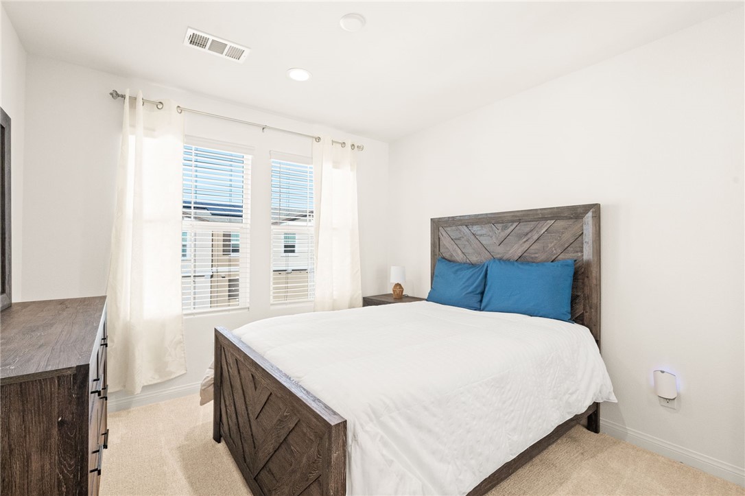 8633 Amherst Street Santee, CA 92071 - Photo 42 of 61 a bedroom with a large bed and a large window