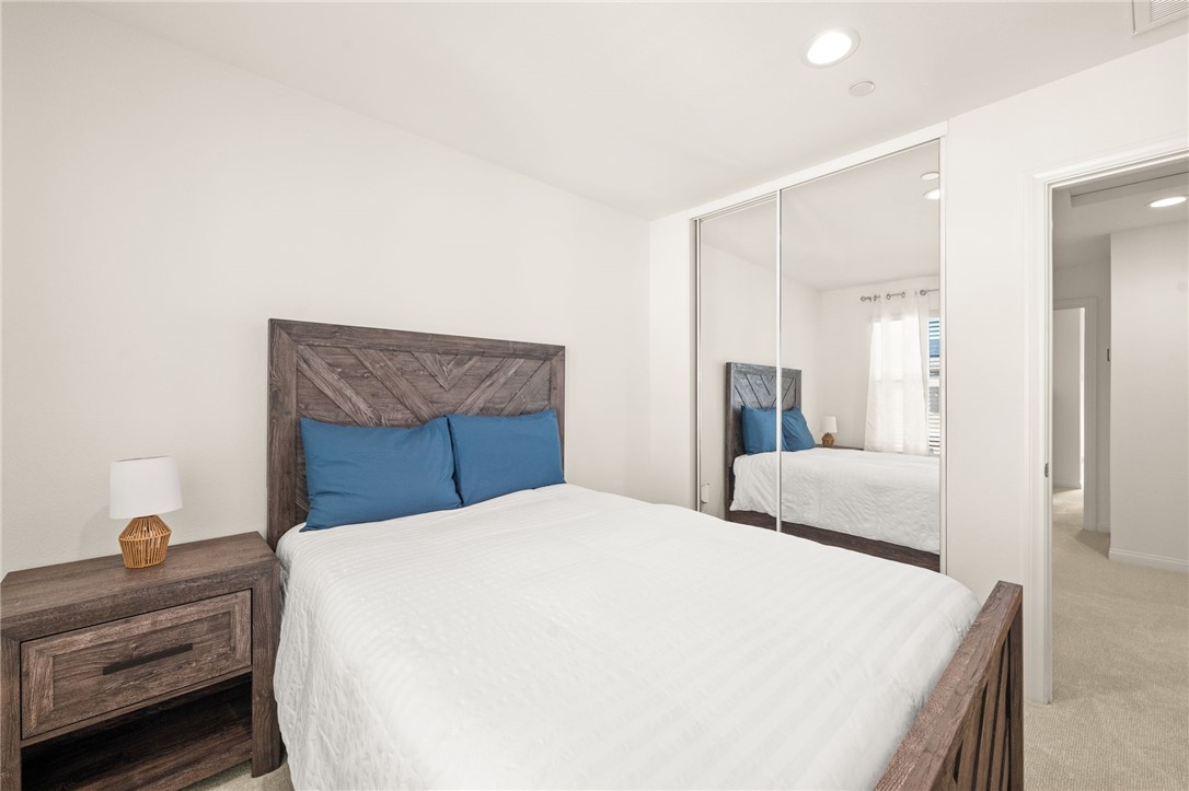 8633 Amherst Street Santee, CA 92071 - Photo 43 of 61 a bedroom with a bed and a large mirror