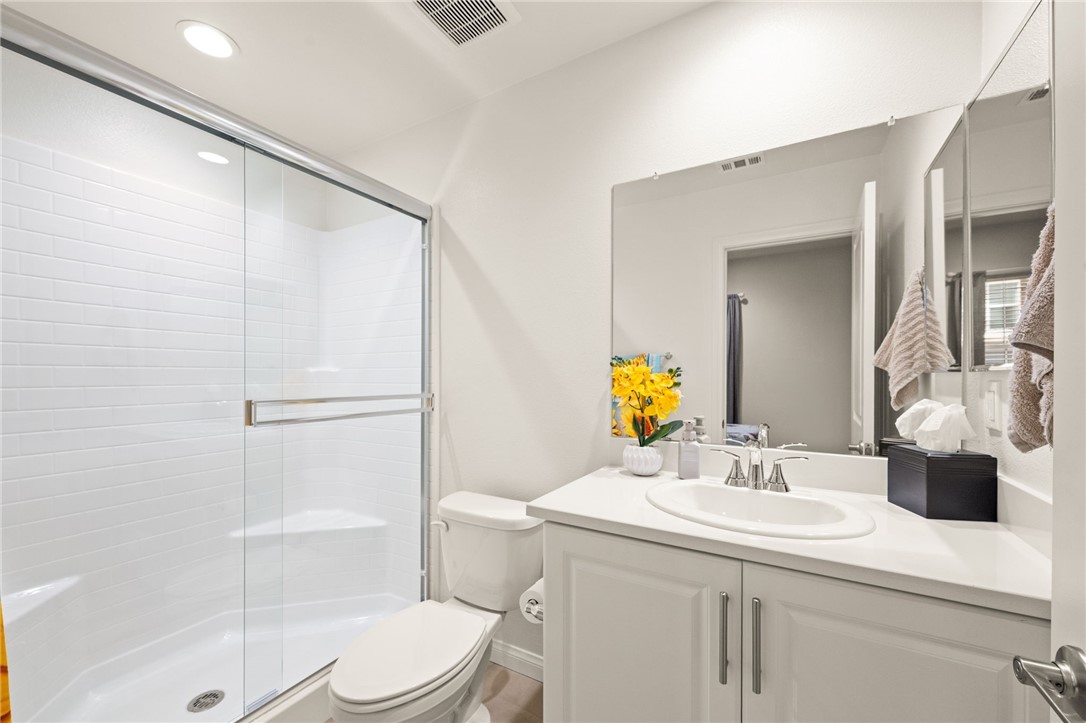8633 Amherst Street Santee, CA 92071 - Photo 7 of 61 a bathroom with a sink toilet vanity and shower