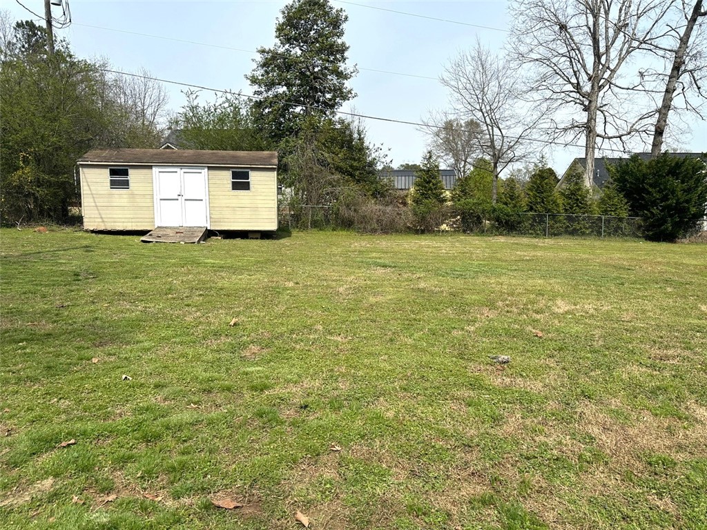 209 Keystone Drive Anderson, SC 29621 - Photo 19 of 20 Expansive green space featuring a convenient shed for storage.