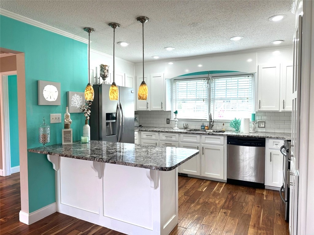 209 Keystone Drive Anderson, SC 29621 - Photo 2 of 20 This modern kitchen features warm wood floors and sleek stainless steel appliances.