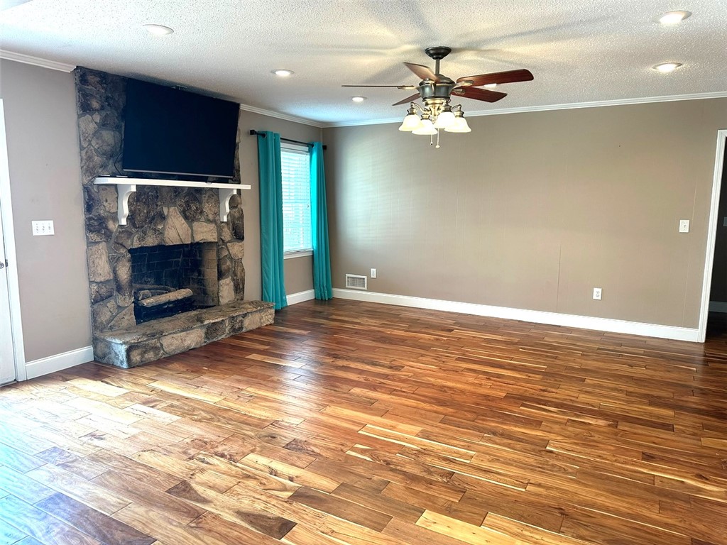 209 Keystone Drive Anderson, SC 29621 - Photo 5 of 20 This inviting living space features rich hardwood flooring and a prominent stone fireplace, perfect for gatherings.