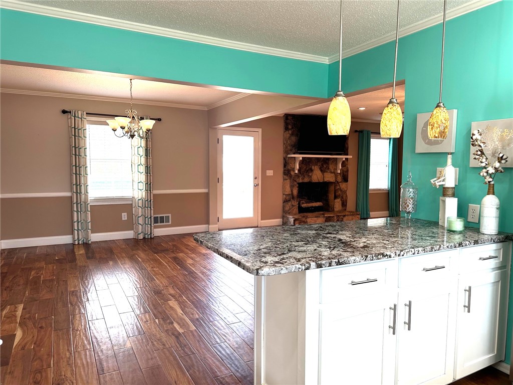 209 Keystone Drive Anderson, SC 29621 - Photo 7 of 20 This inviting space features an open layout, hardwood flooring, and a stone fireplace.