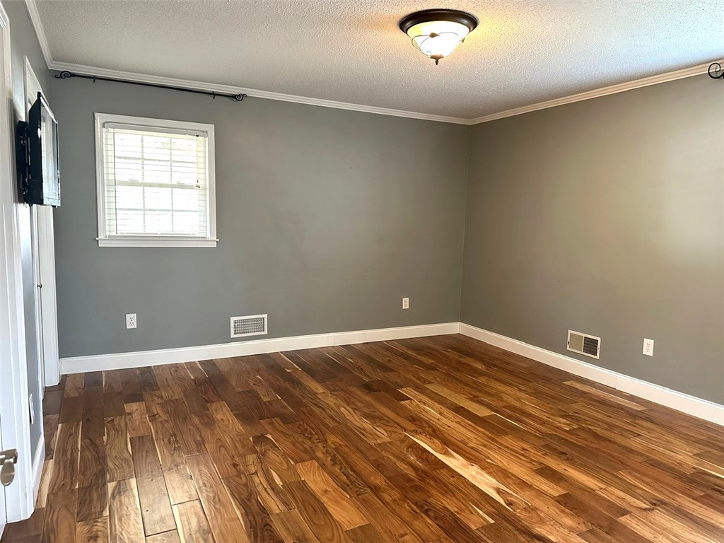 209 Keystone Drive Anderson, SC 29621 - Photo 8 of 20 This inviting room features warm wood flooring and ample natural light, creating a comfortable ambiance.