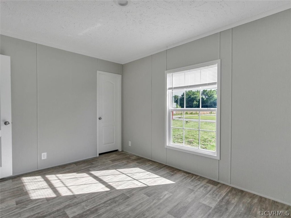 Tbd Railroad Avenue Dendron, VA 23839 - Photo 19 of 22 an empty room with wooden floor and windows