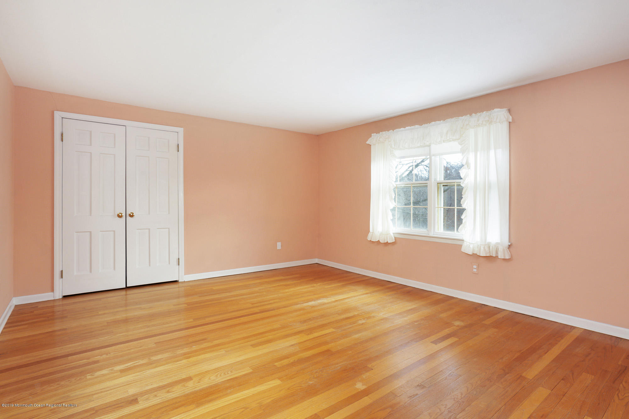 250 Newman Springs Road Colts Neck, NJ 07722 - Photo 18 of 43 a view of an empty room with wooden floor and a window