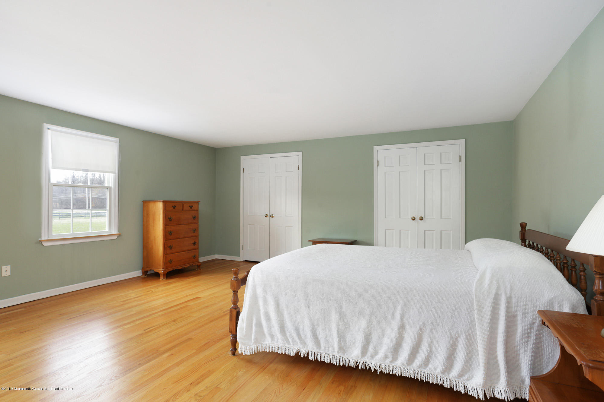 250 Newman Springs Road Colts Neck, NJ 07722 - Photo 20 of 43 a bedroom with a bed and wooden floor