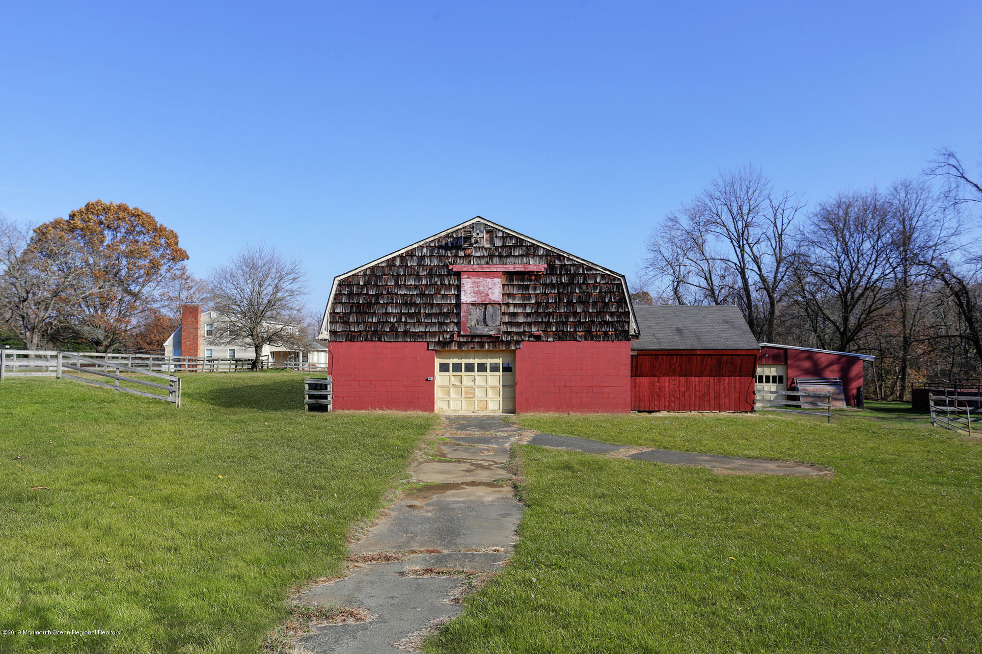 250 Newman Springs Road Colts Neck, NJ 07722 - Photo 31 of 43 a large building with a yard and trees in the background