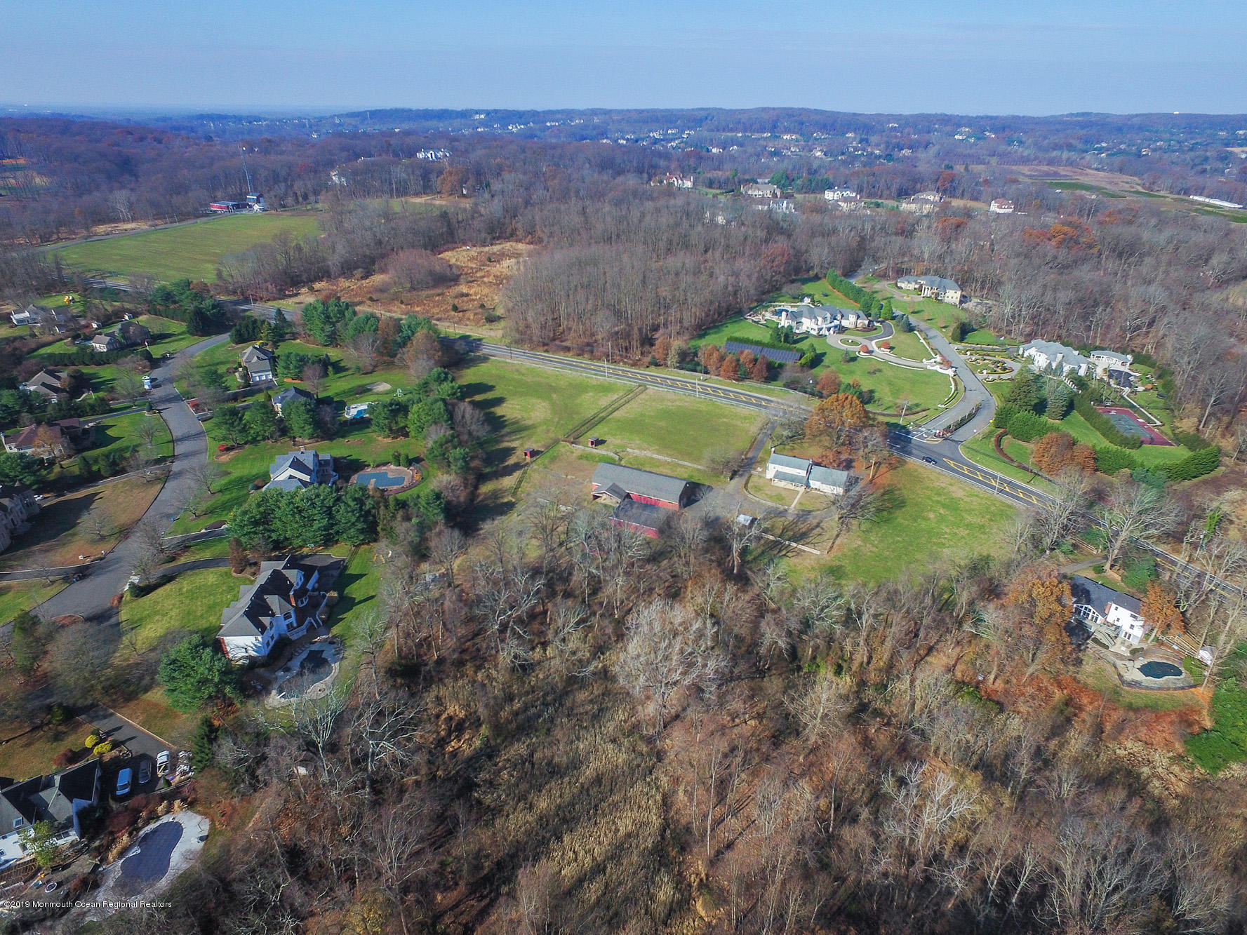 250 Newman Springs Road Colts Neck, NJ 07722 - Photo 36 of 43 a view of a lake with a building in the background