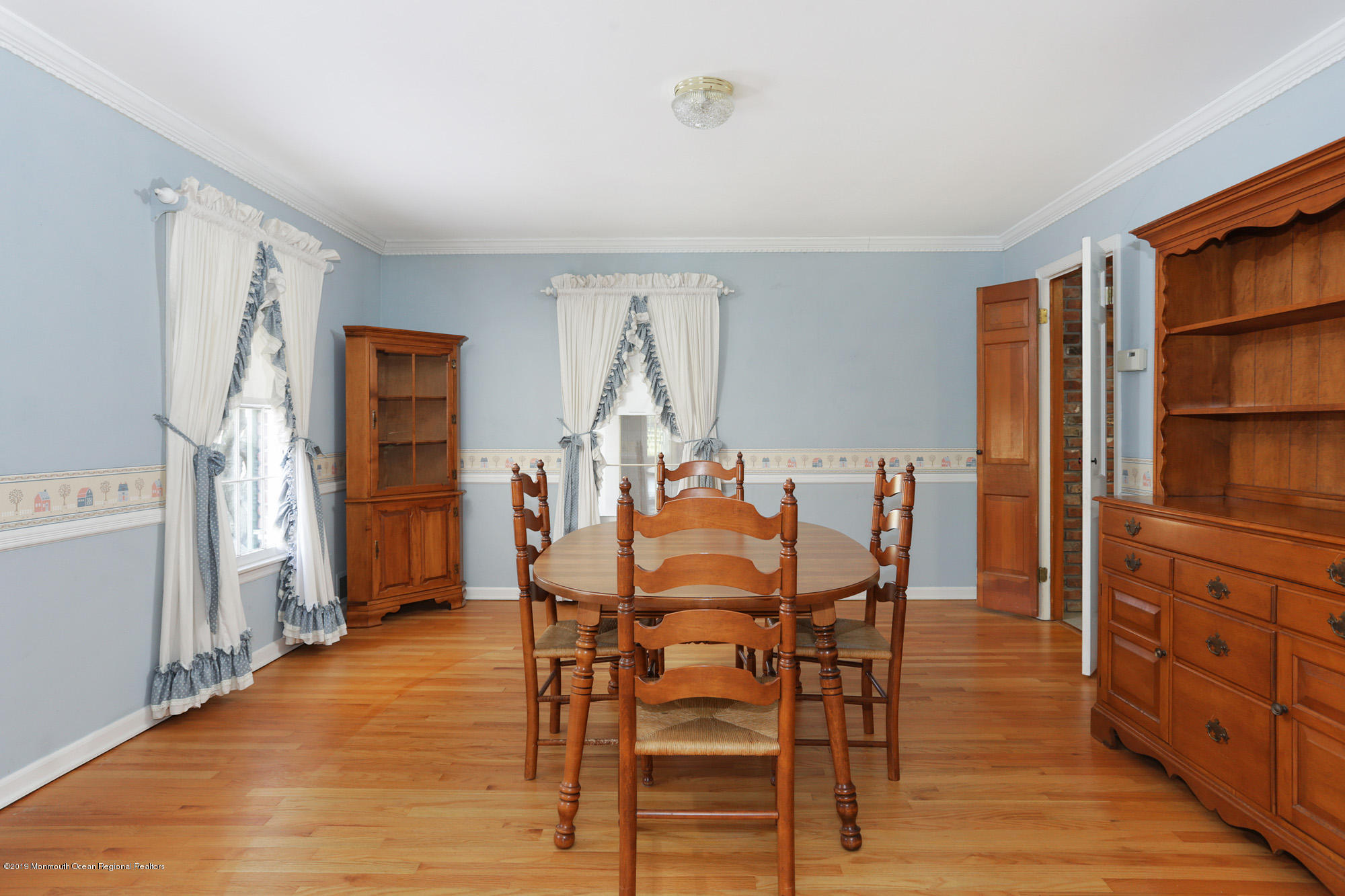 250 Newman Springs Road Colts Neck, NJ 07722 - Photo 8 of 43 a view of a dining room with furniture and wooden floor