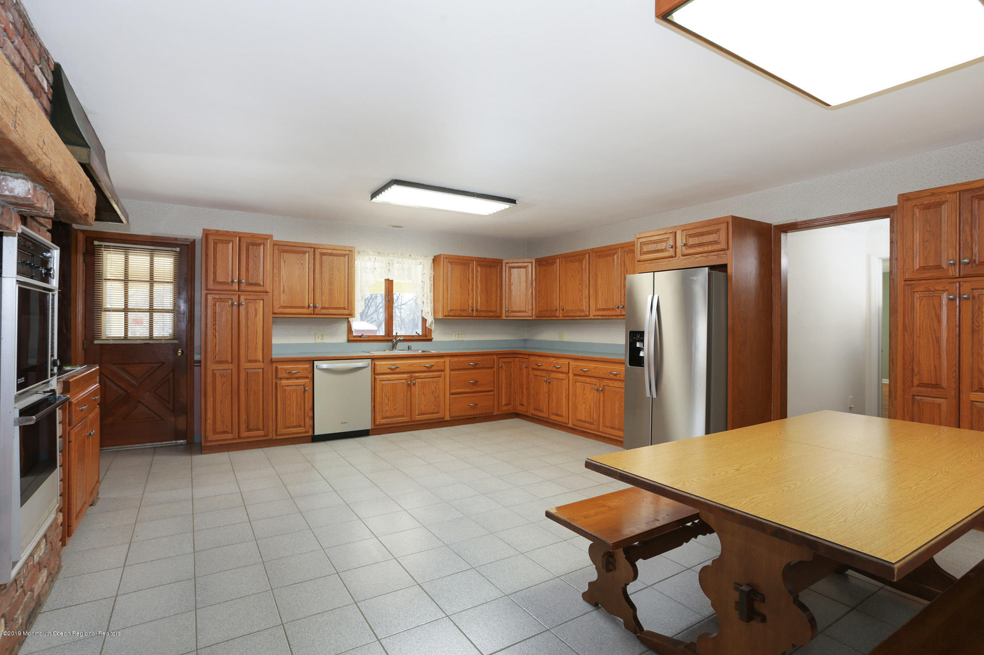 250 Newman Springs Road Colts Neck, NJ 07722 - Photo 9 of 43 a kitchen with stainless steel appliances a refrigerator sink and cabinets