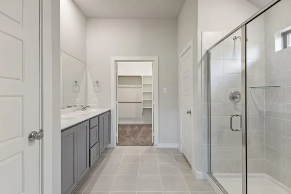 a bathroom with a shower sink and mirror