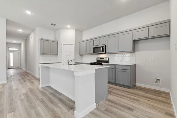a kitchen with counter top space cabinets and stainless steel appliances