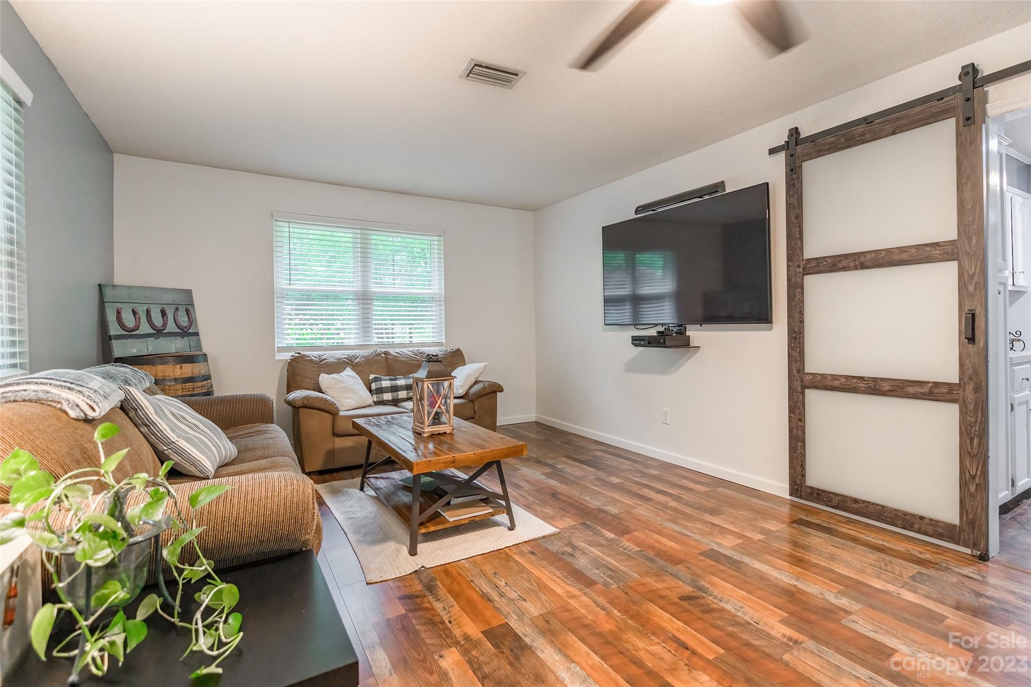 176 Hatchway Road Indian Land, SC 29707 - Photo 4 of 28 a living room with furniture a flat screen tv and a window