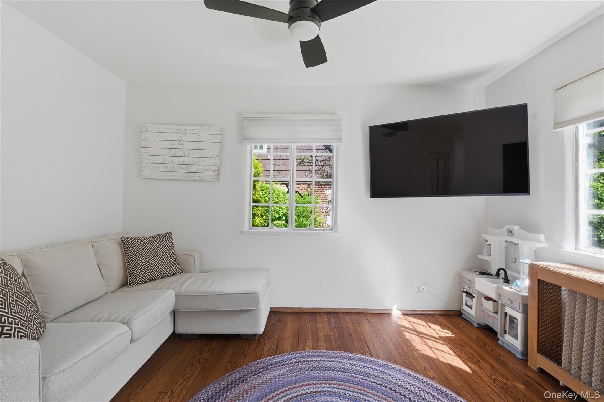 15 Kingsbury Road New Rochelle, NY 10804 - Photo 13 of 30 a living room with furniture and a flat screen tv