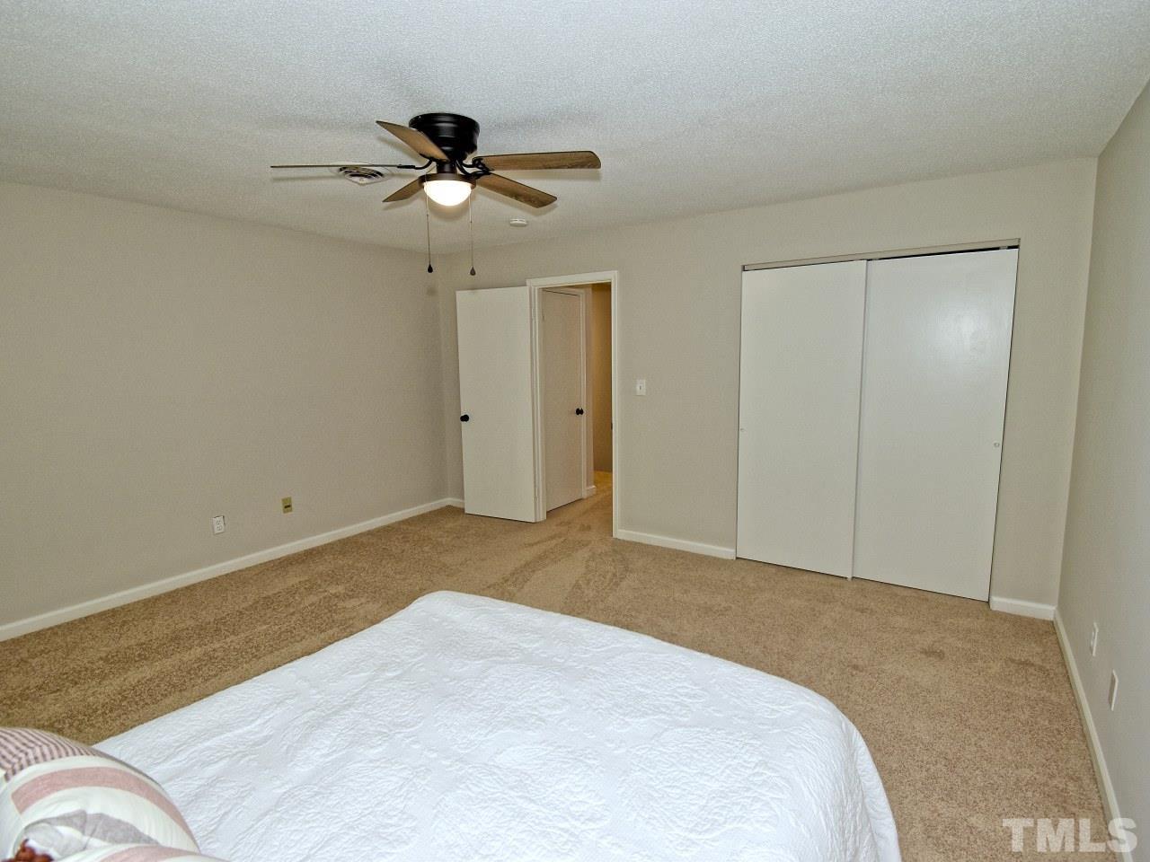 1120 Nottingham Circle Cary, NC 27511 - Photo 11 of 22 a bedroom with a bed and a chandelier