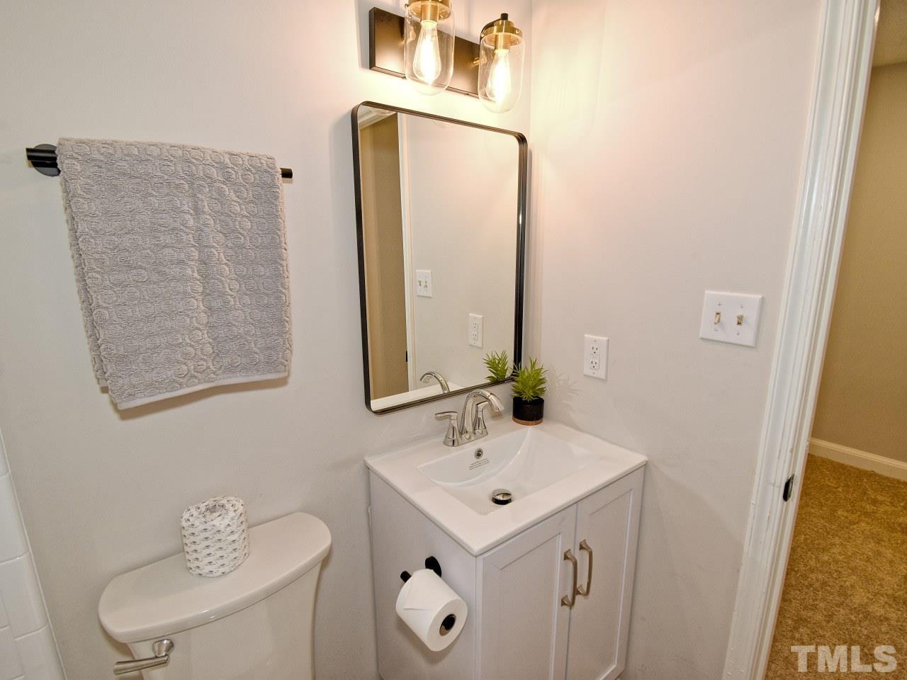 1120 Nottingham Circle Cary, NC 27511 - Photo 15 of 22 a bathroom with a sink a toilet and mirror