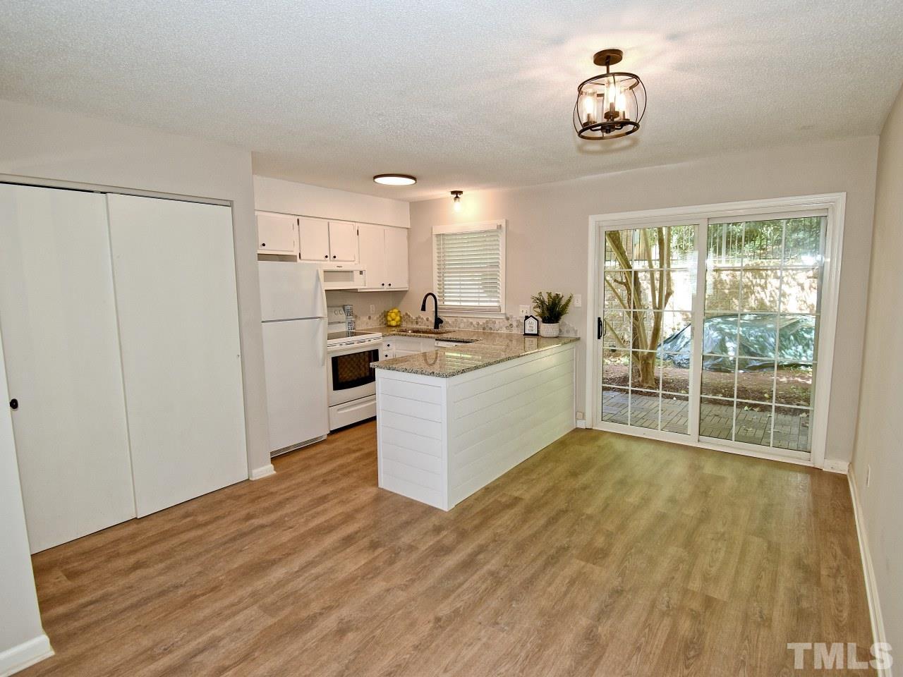 1120 Nottingham Circle Cary, NC 27511 - Photo 4 of 22 a view of a kitchen with furniture and wooden floor