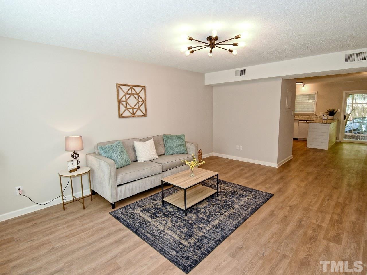 1120 Nottingham Circle Cary, NC 27511 - Photo 9 of 22 a living room with furniture and wooden floor
