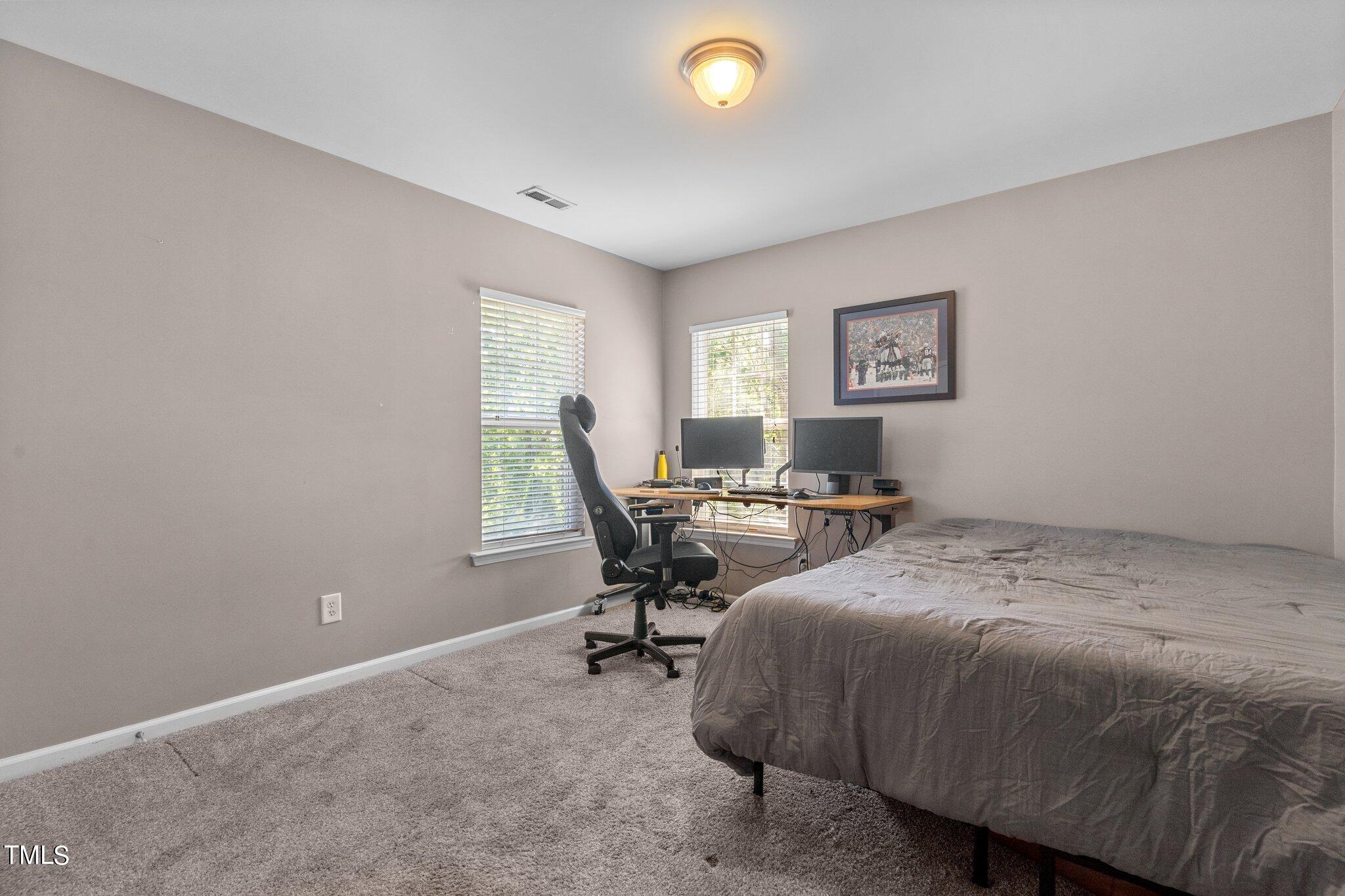 5016 Paperbark Court Durham, NC 27713 - Photo 21 of 35 a bed room with a bed and a desk