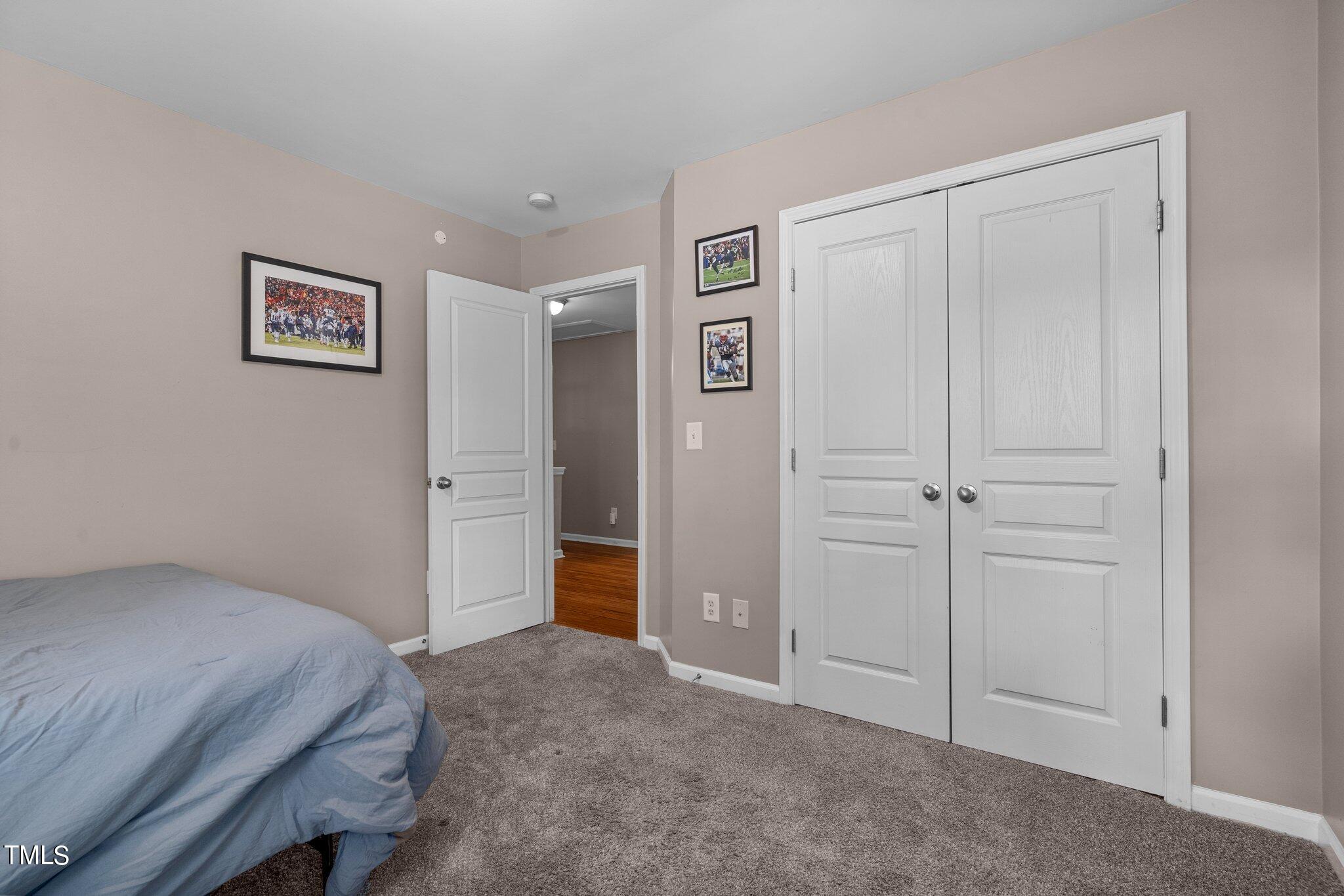 5016 Paperbark Court Durham, NC 27713 - Photo 22 of 35 a bedroom with a bed and a view of bathroom