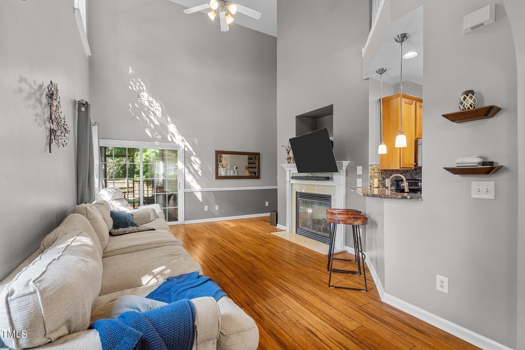 5016 Paperbark Court Durham, NC 27713 - Photo 6 of 35 a living room with furniture fireplace and a flat screen tv