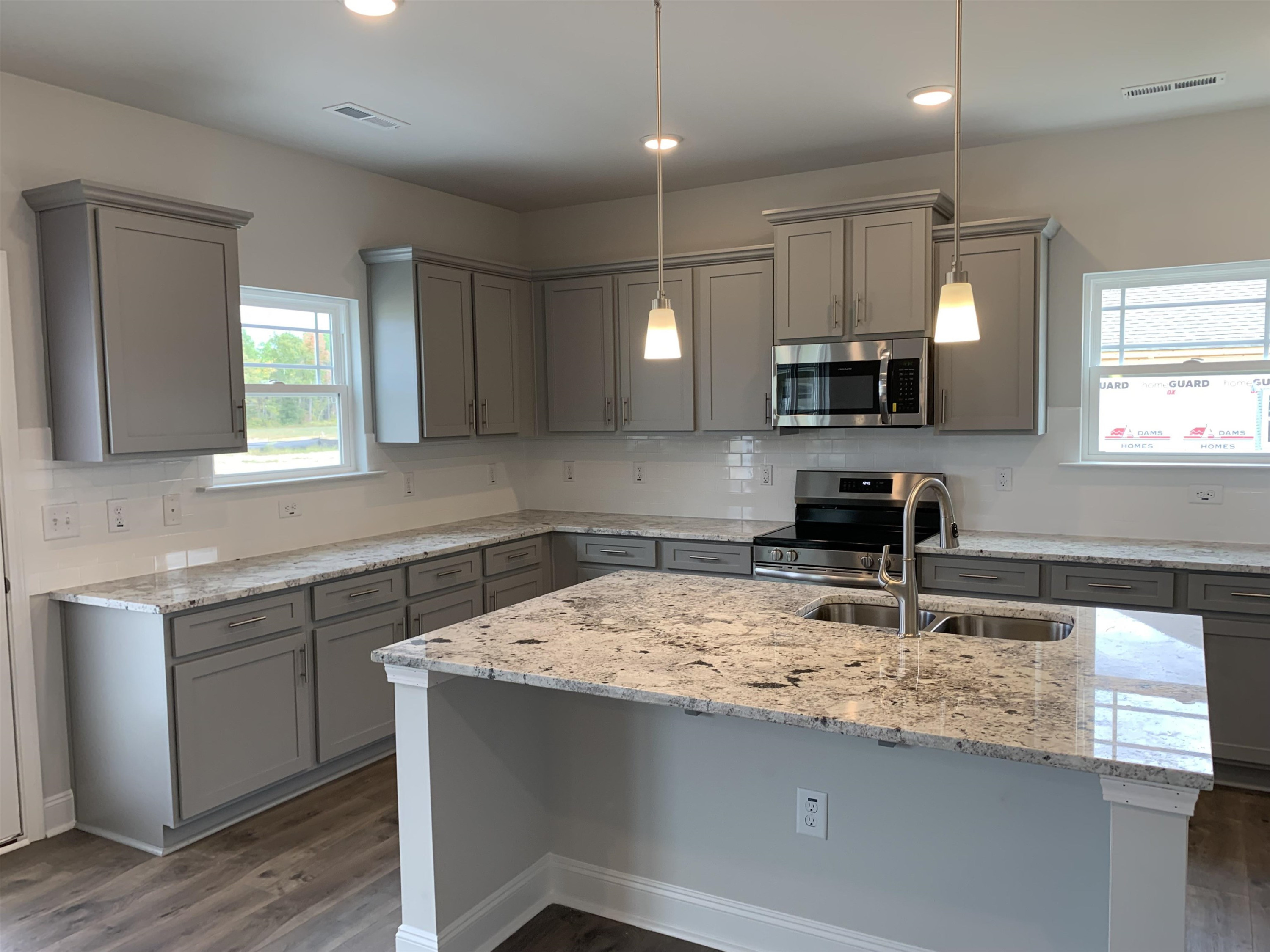 8433 Shallow Crk Trail Bailey, NC 27807 - Photo 4 of 17 a kitchen with kitchen island granite countertop a sink a counter top space appliances and cabinets