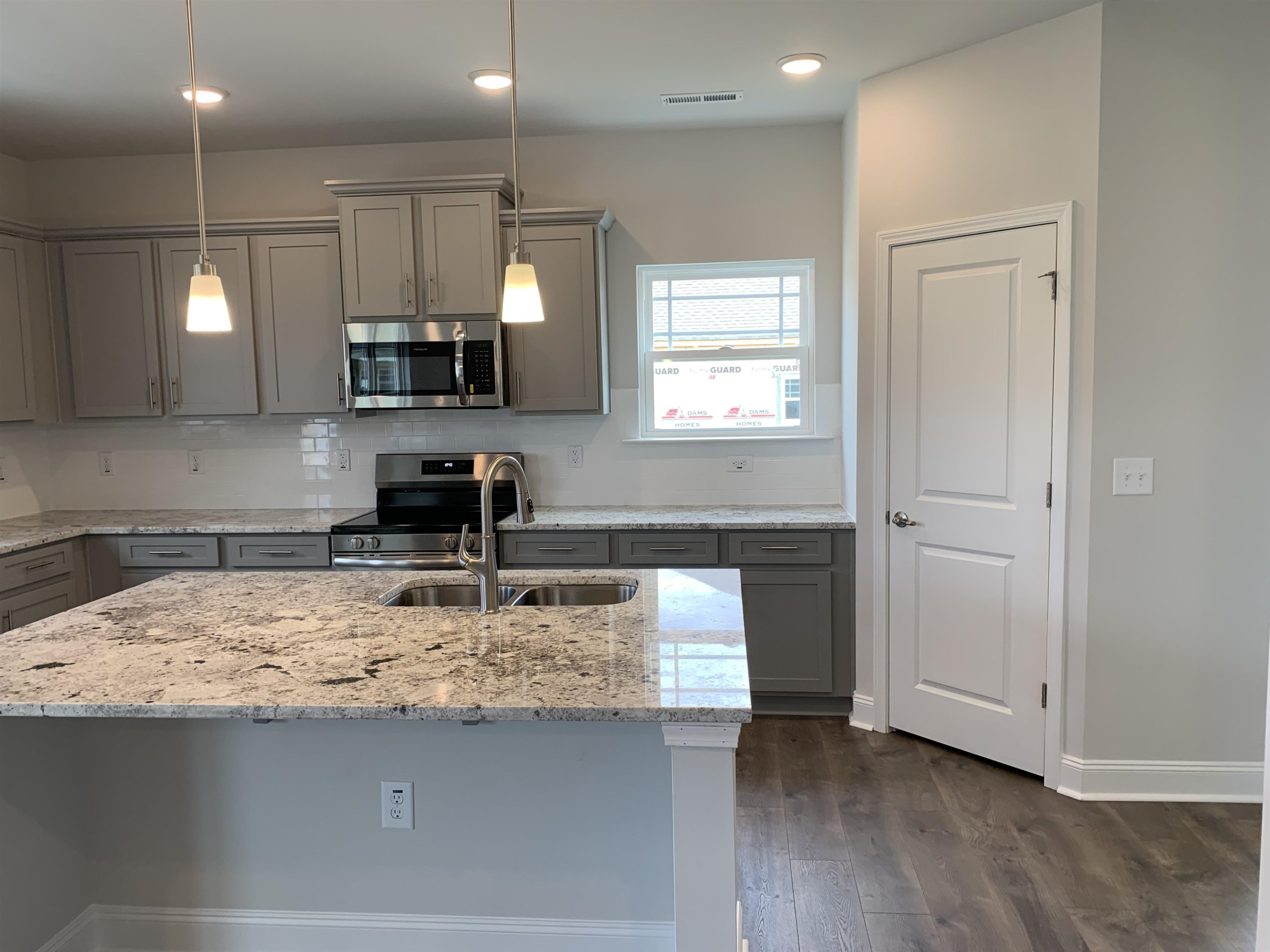 8433 Shallow Crk Trail Bailey, NC 27807 - Photo 5 of 17 a kitchen with a sink a stove and cabinets