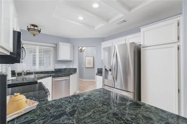 a kitchen with refrigerator and cabinets
