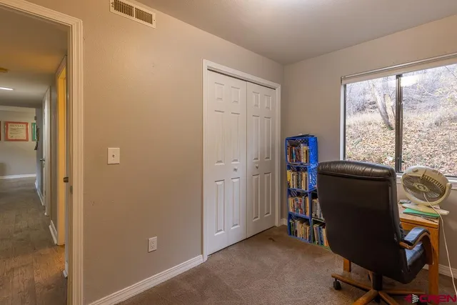 a bedroom with a bed and a cabinet